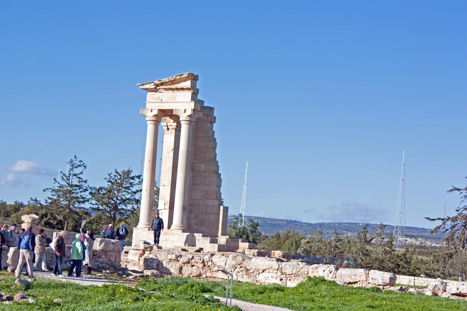 The temple of Apollo Hylates at Kourion: the two columns, entablature and side wall of the south-west corner, re-erected in the 1980s, rise far above the low remains of the rest of the building. Photo: Wknight94, CC BY-SA 3.0.