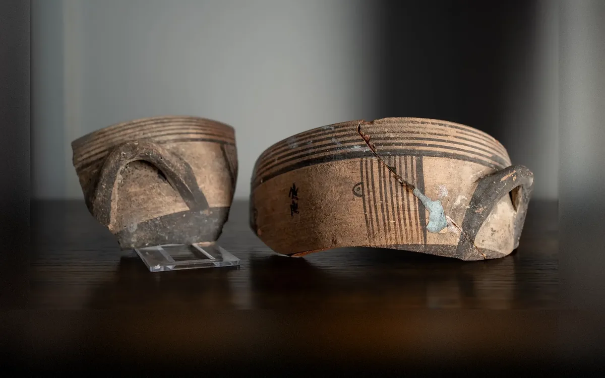 Two Fragments of a White Painted Deep Bowl with Panel Decoration