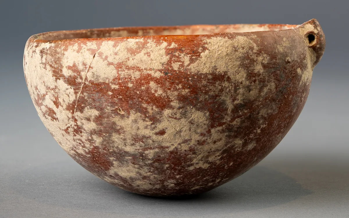 Red Polished Bowl with Pierced Lug, under Burial Crust