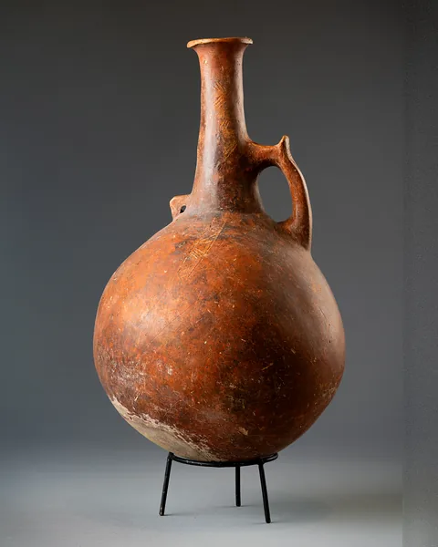 Large Red Polished Jug with Horned Handle and Pierced Lug