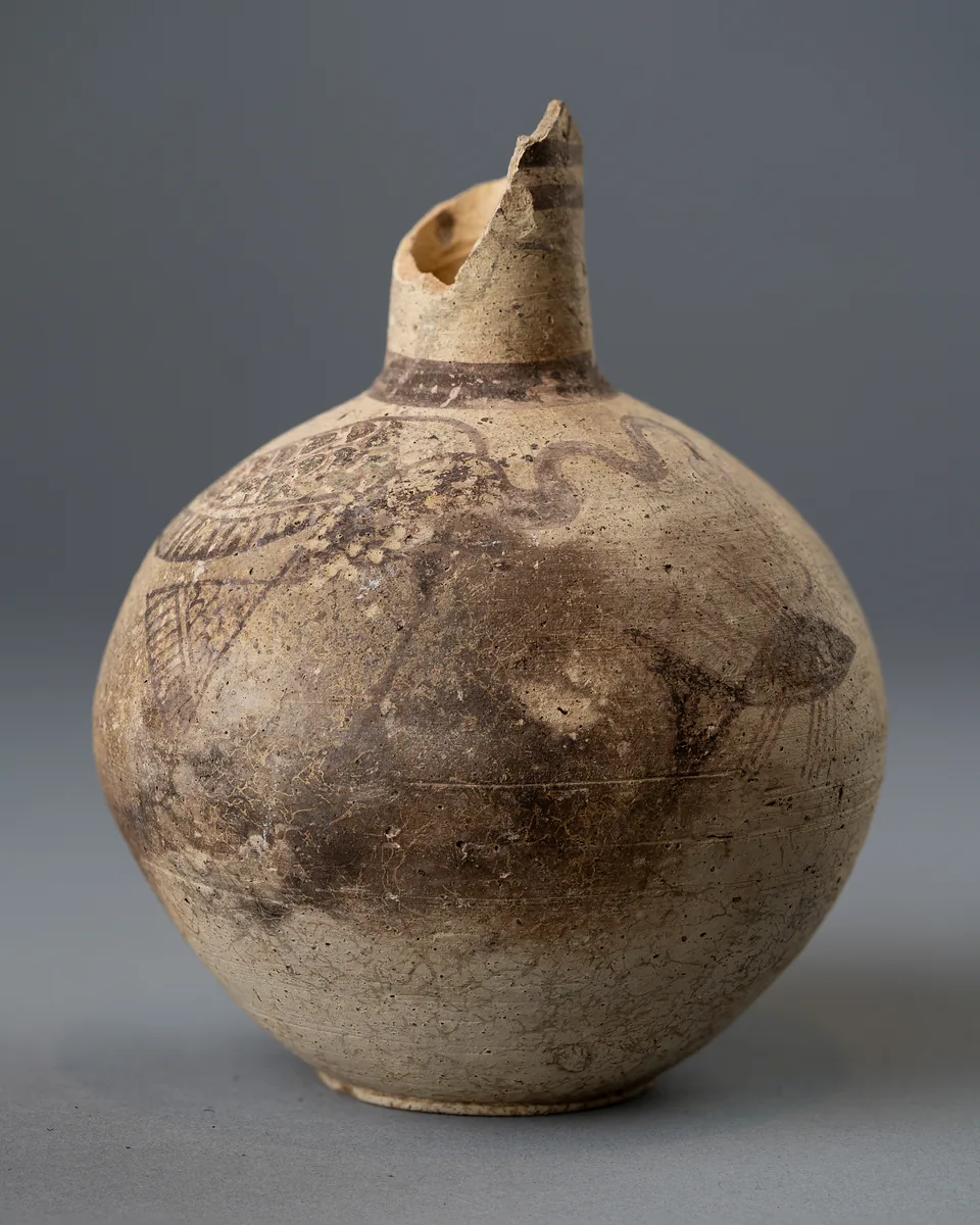 Small round jug, its mouth broken away, painted with a long-necked waterfowl and a fish and clouded grey by smoke