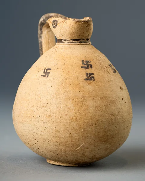 White Painted Trefoil Jug with Painted Eyes and Swastikas