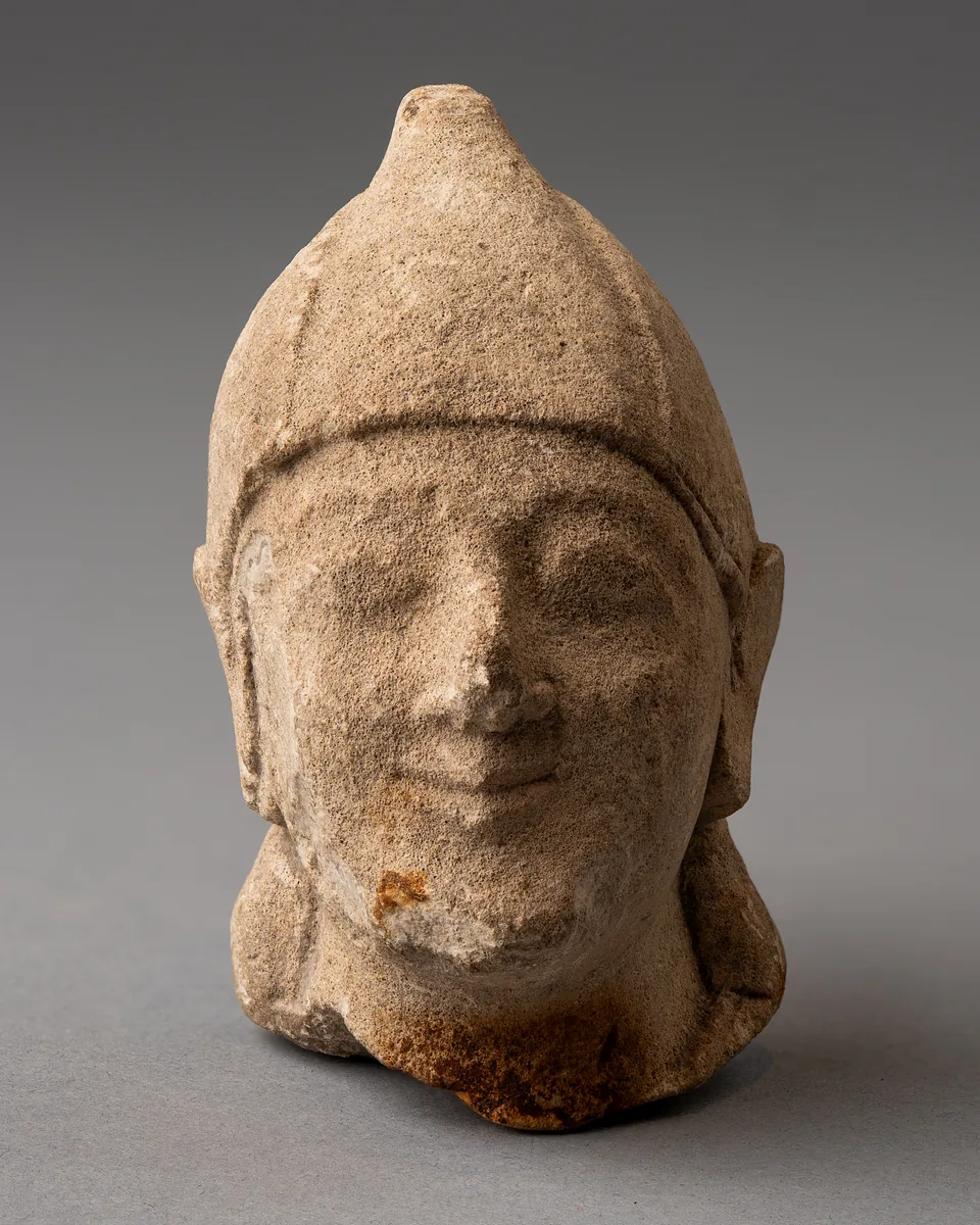 Limestone Head of a Beardless Votary in a Conical Helmet