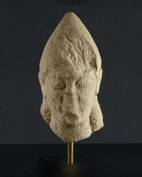 Weathered Limestone Head of a Votary in a Tall Pointed Cap