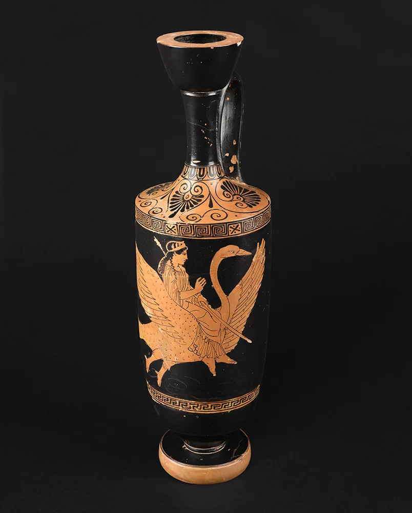 Tall black oil flask painted in red-figure with a woman seated on a swan in flight