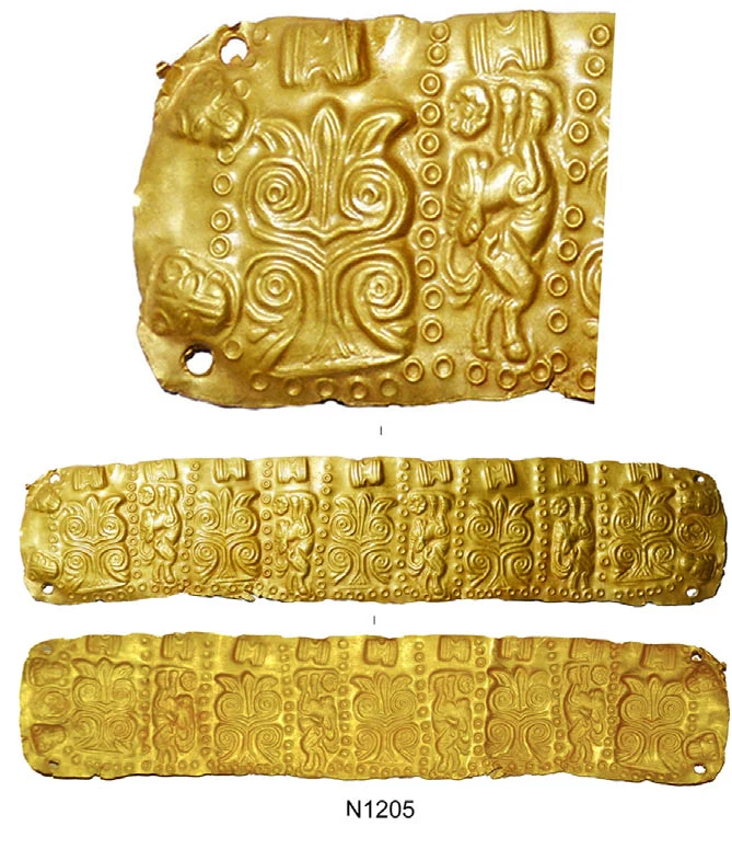 Detail of a dented gold sheet with an embossed palm-like plant, a leaping horned animal and a row of small dots, above both faces of a gold band with repeating panels and holes at the corners