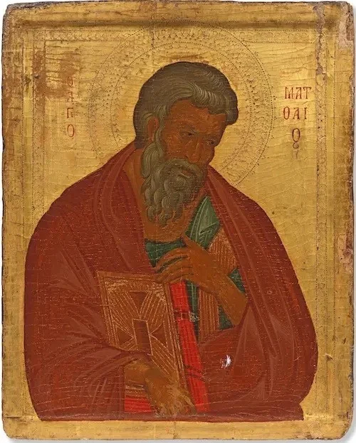 Painted icon on a gold ground of a grey-bearded saint in a red cloak holding a closed book, with his name in red Greek letters beside his head