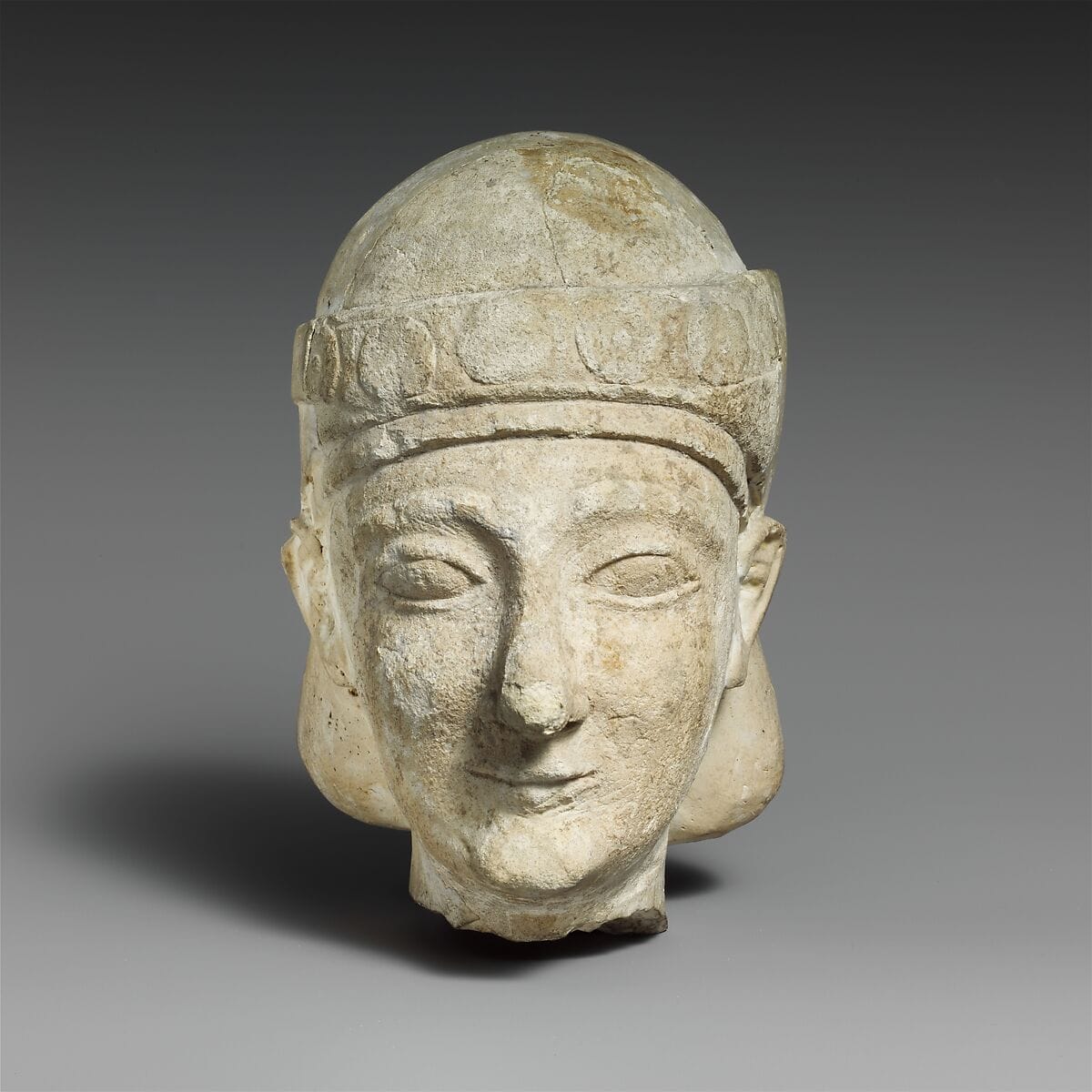 Limestone head of a beardless male with a diadem, Archaic II Cypriot statue