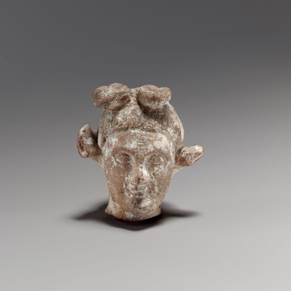 Terracotta head of a youth with a goat headdress, Hellenistic Cypriot statue