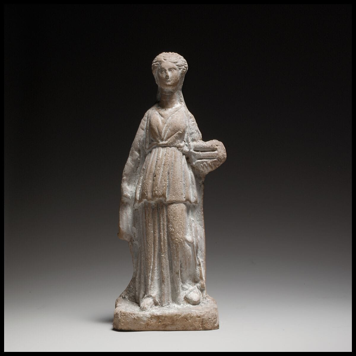 Terracotta figuring of a standing female votary holding a box, Hellenistic Cypriot statue