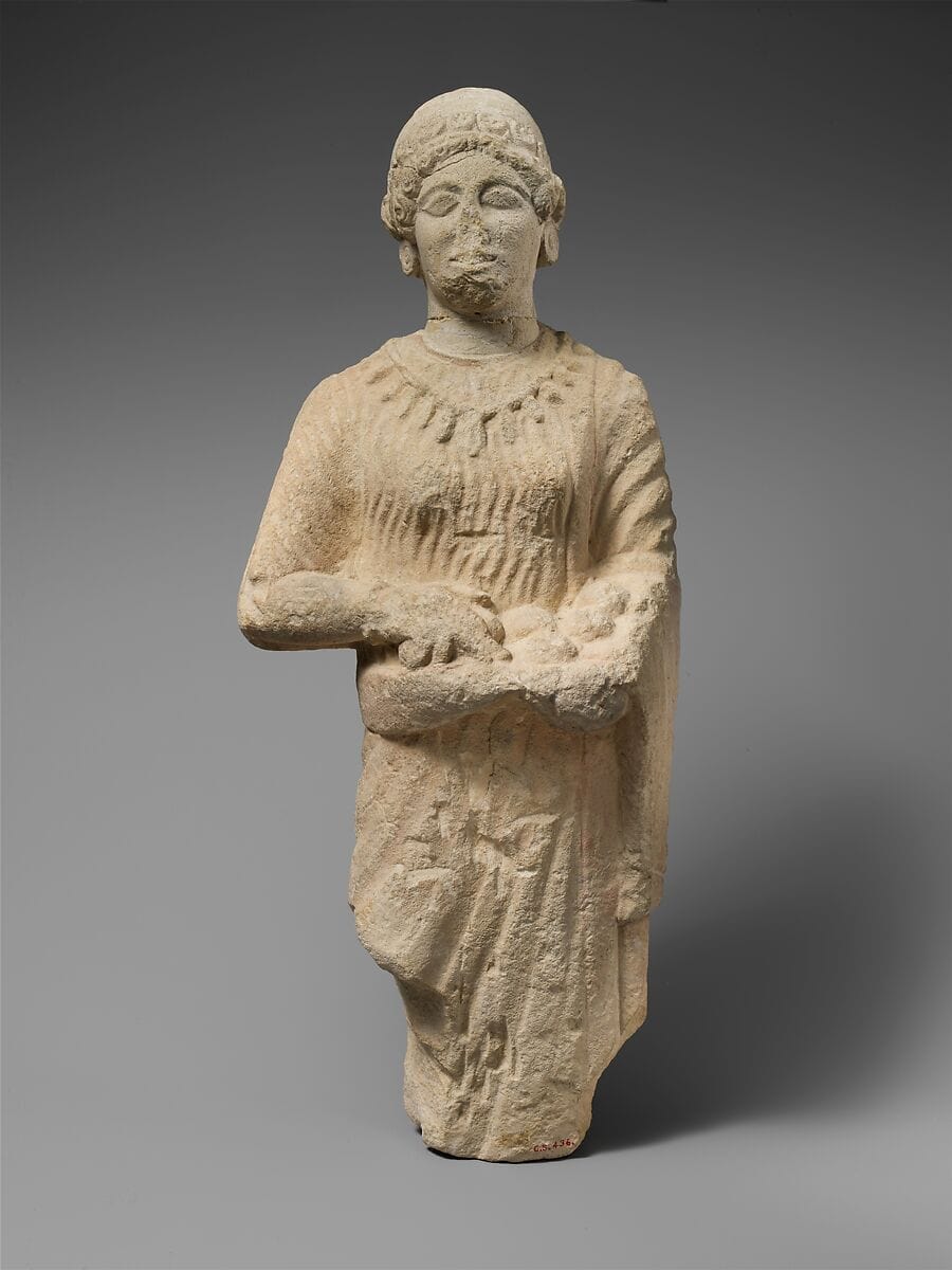 Limestone statuette of a female votary holding pieces of fruit, Classical Cypriot