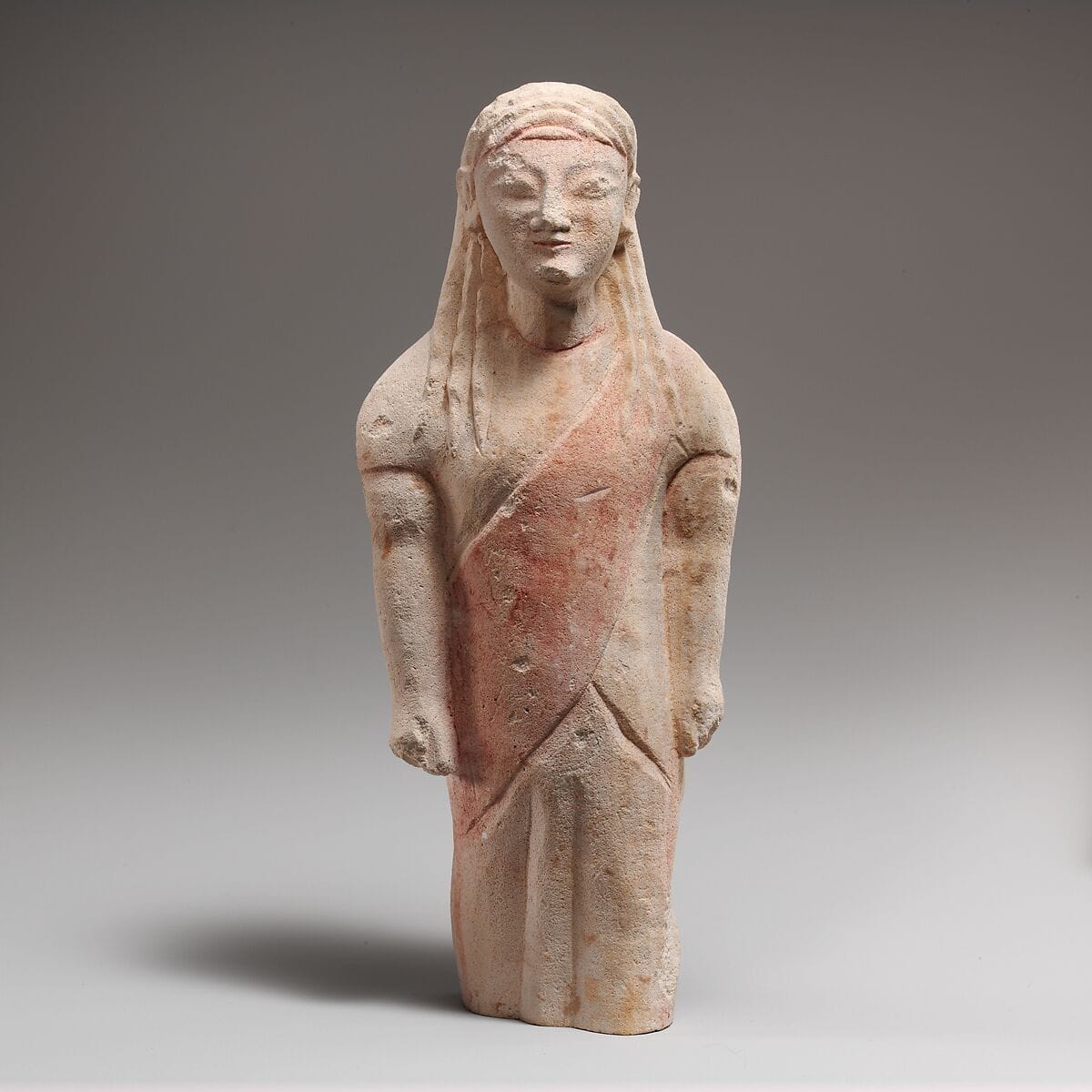 Limestone statuette of beardless male votary in Greek dress, Archaic II Cypriot