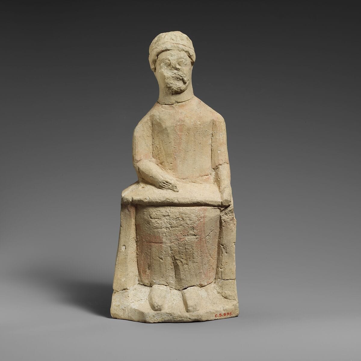 Limestone statuette of a seated beardless male votary writing on a scroll, Classical Cypriot