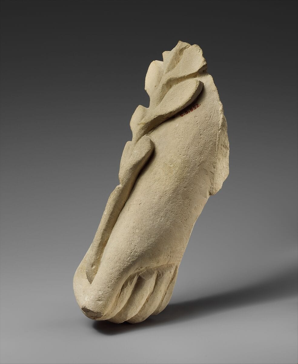 Limestone hand holding a branch of leaves, Archaic II Cypriot