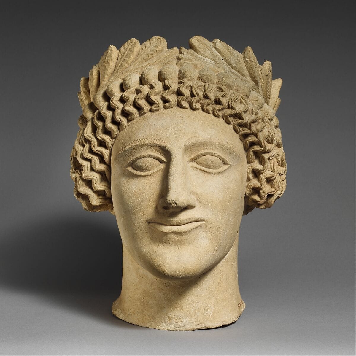 Limestone head of a youth with wreath, Classical Cypriot statue