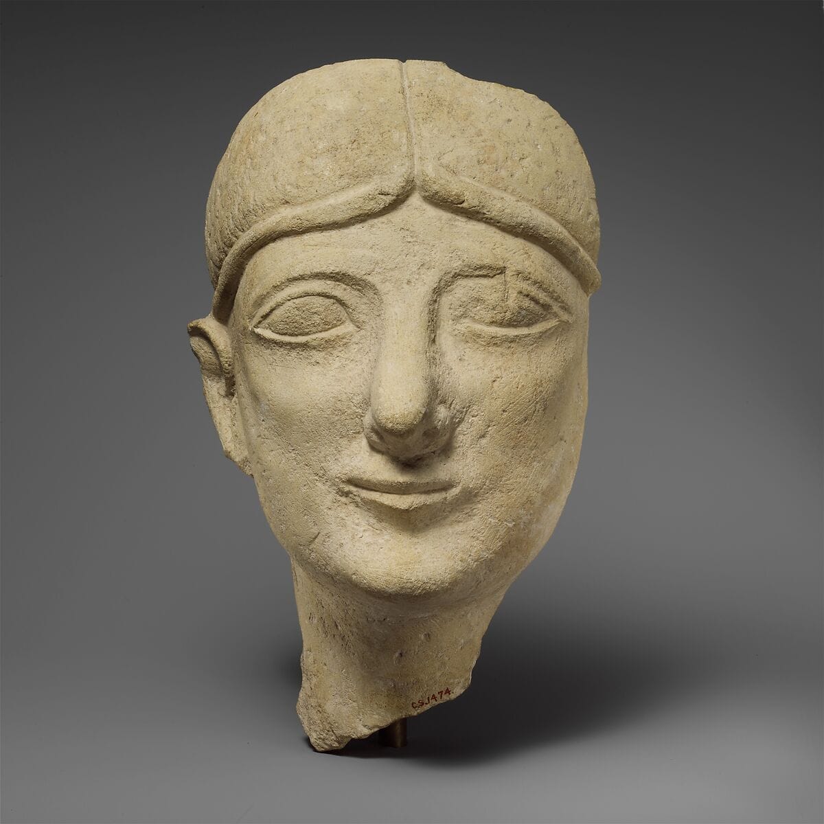 Limestone head of a beardless male with a fillet, Archaic II Cypriot statue