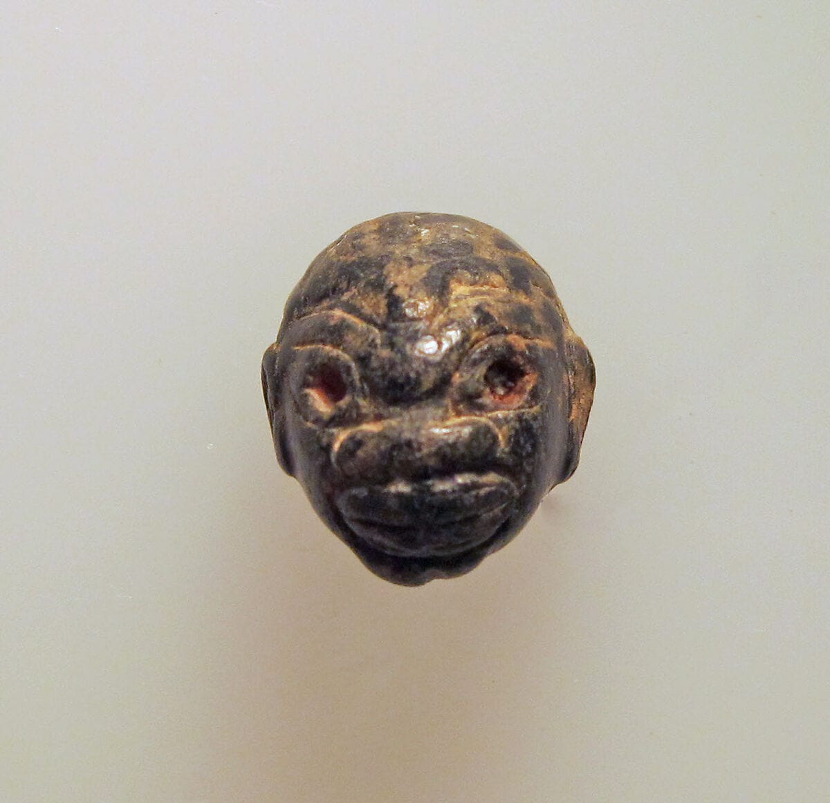 Chlorite pendant in the shape of a Black African's head, Bronze Age Cypriot jewelry