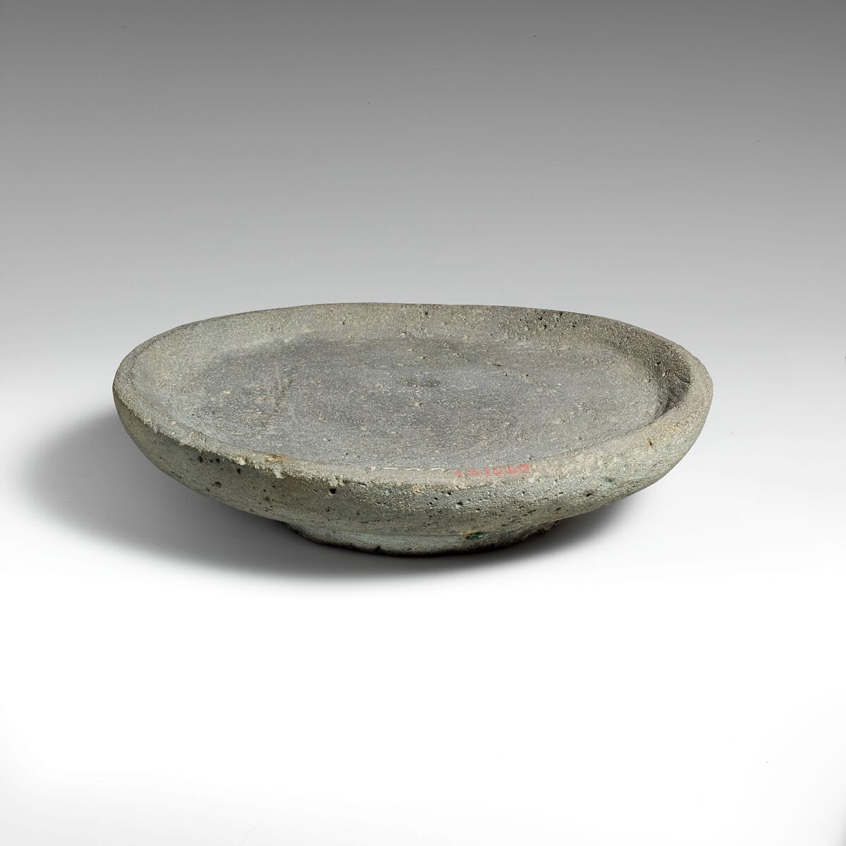 Vesicular basalt mortar or plate, Late Bronze Age II Cypriot dish